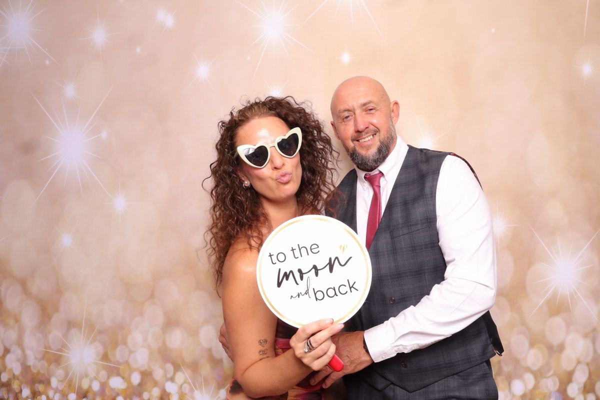 Couple with a to the moon and back prop